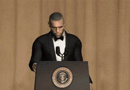 a man stands at a podium with the seal of the president of the united states
