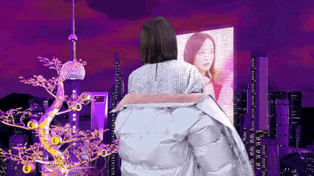 a woman in a white jacket is looking at a billboard with a picture of a girl on it