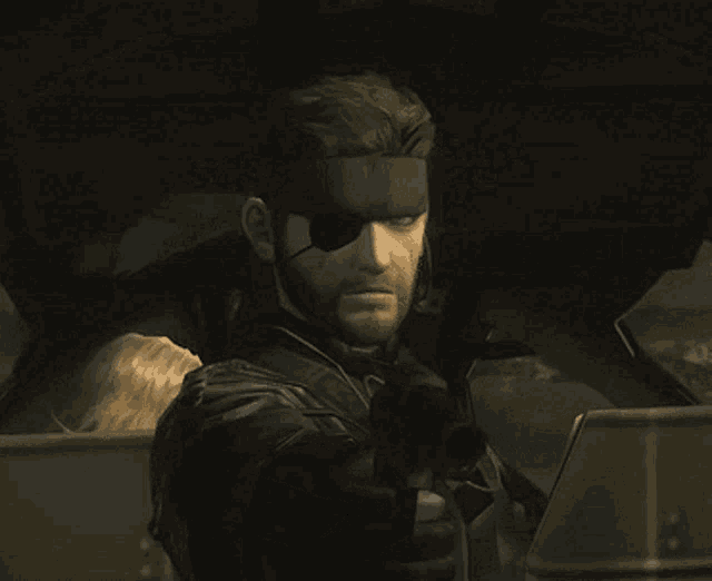 a man with a bandage on his eye is wearing a leather jacket