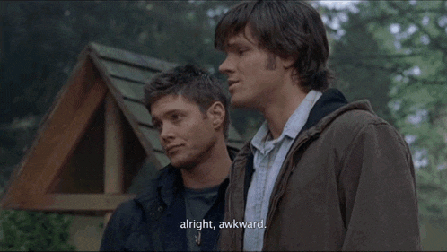 two men are standing next to each other and one of them says " alright awkward "