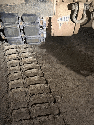 a close up of a tractor 's tracks with the letters abc on it