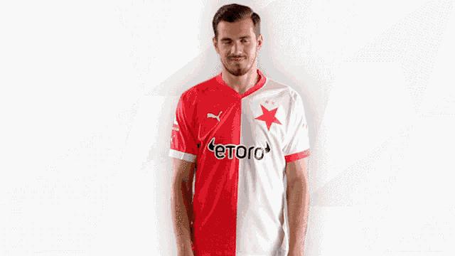 a man wearing a red and white jersey with etoro written on it