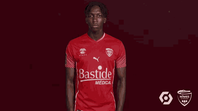 a man in a red bastide medical shirt