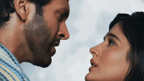 a man and a woman are looking at each other with their mouths open