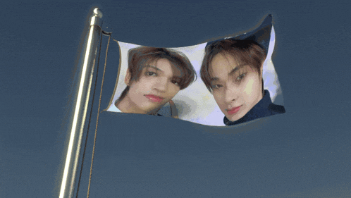 a picture of two men on a flag with a blue sky in the background