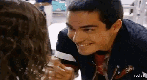 a man and a woman are smiling at each other .