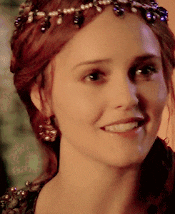 a close up of a woman 's face wearing a tiara and smiling