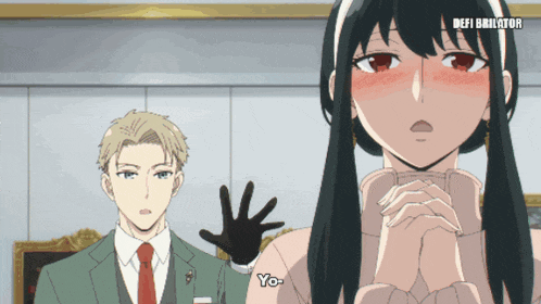 a man in a suit and tie stands next to a woman in a white sweater that says yo