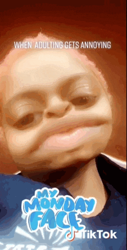 a child is making a funny face while wearing a blue shirt that says " my monday face "
