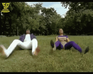 two people laying in the grass with the sp logo on the bottom right