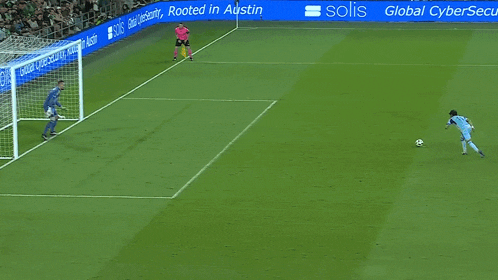 a soccer game is being played on a field with a sign that says sos