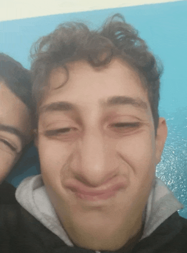 a close up of a person making a face