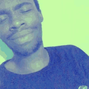 a close up of a man 's face with his eyes closed and a black shirt on