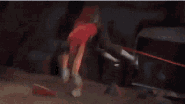 a person is laying on the ground with a red light coming out of their head .
