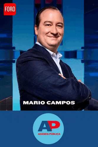 a man in a suit is standing with his arms crossed in front of a sign that says mario campos