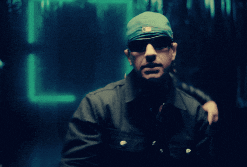 a man wearing sunglasses and a bandana with the letter a on it