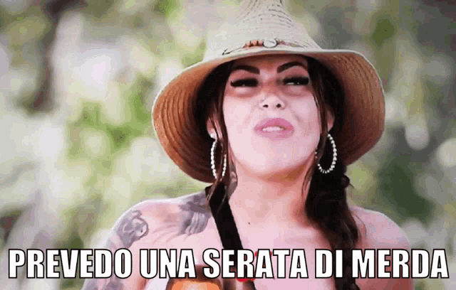 a woman wearing a straw hat and hoop earrings says " precededo una serata di merda "