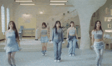 three women are dancing in a room with stairs