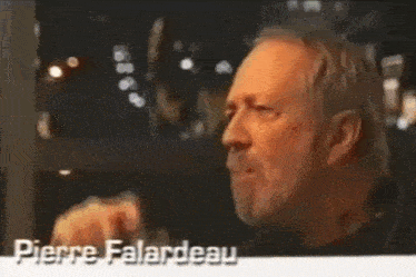 a man with a beard is talking in french