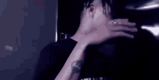 a close up of a person 's neck and arm with a tattoo on it .