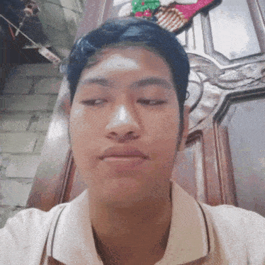 a young man is taking a selfie in front of a door