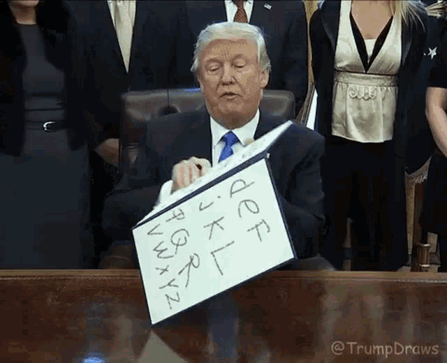 a man in a suit and tie is holding a piece of paper that says jeff