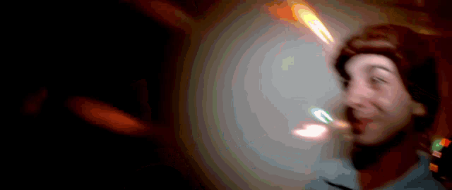 a blurry picture of a person with a flame coming out of their head