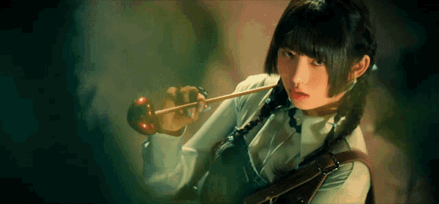a girl with pigtails holds a sword in her hand