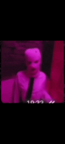 a person wearing a pink ski mask with their mouth open .