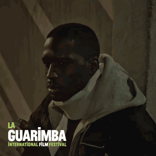 a poster for the la guarimba international film festival with a man smoking a cigarette