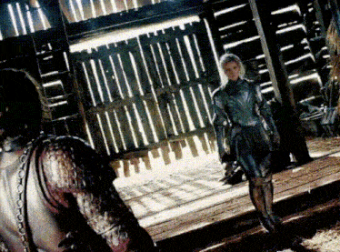 a man and a woman are standing next to each other in a barn .
