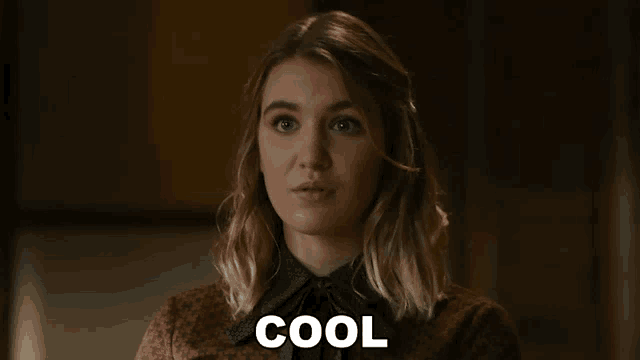 a close up of a woman 's face with the word cool above her .
