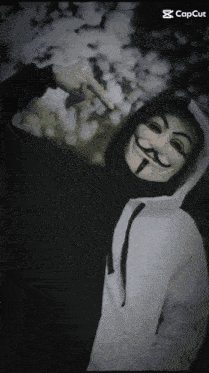 a person wearing a mask and a white hoodie with capcut written in the corner