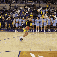 a man is dribbling a basketball on a court