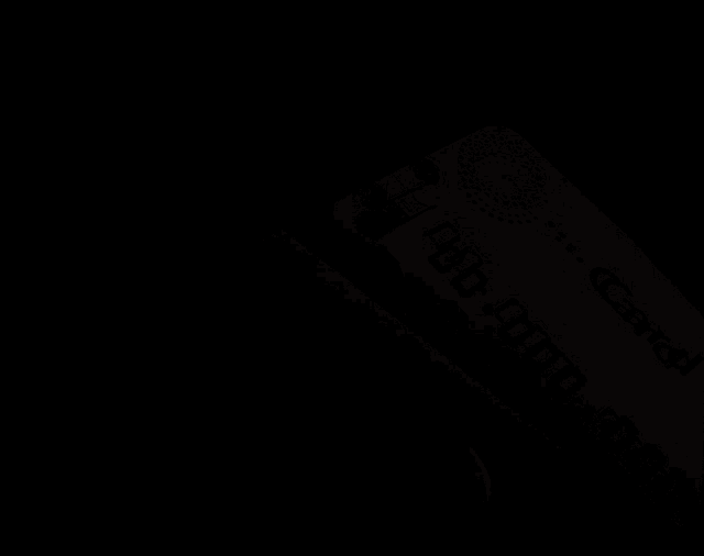 a close up of a red and silver credit card with the letters g on it