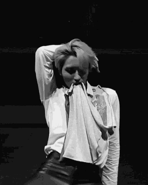 a black and white photo of a man in a white shirt