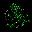 a blurred image of a christmas tree made of green lights on a black background .