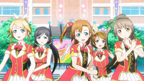 a group of anime girls are posing for a picture in front of a building with a banner that says " love live "