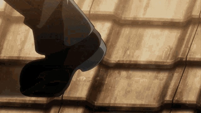 a person 's foot is standing on a wooden surface