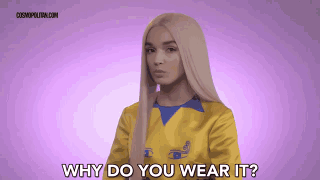a woman is wearing a yellow and blue sweater and asking why do you wear it