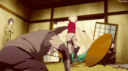 a girl in a red top is kicking a man in the face .