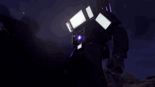 a bald man wearing glasses and a headset stands in front of a robot