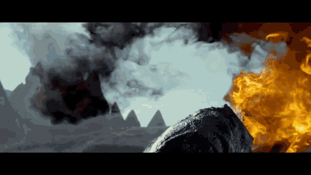 smoke and fire are coming out of a rock