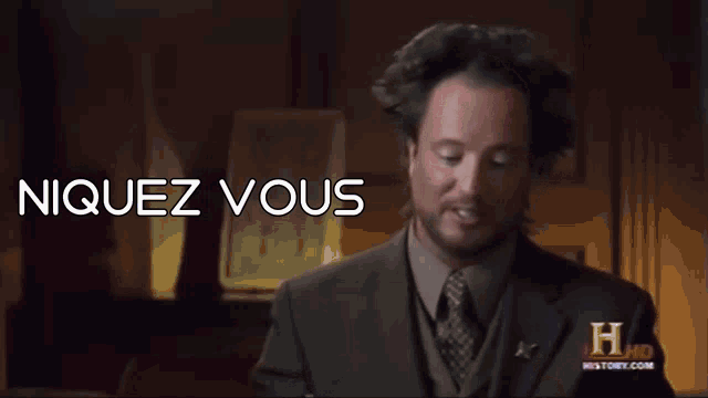 a man in a suit and tie with the words niquez vous above him