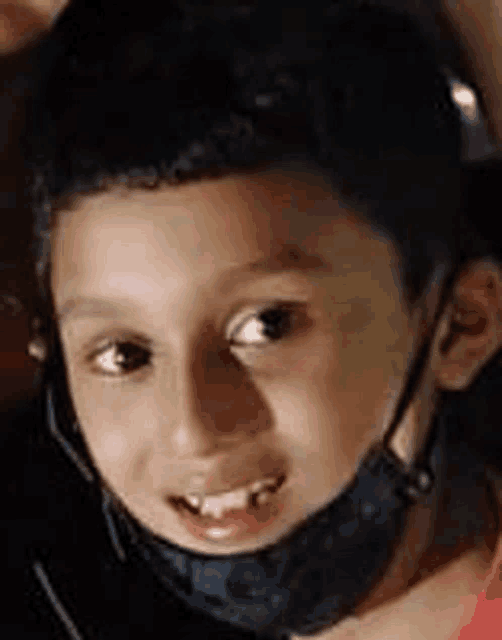a close up of a young boy wearing a helmet and a mask .