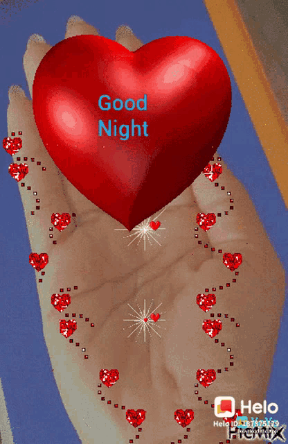 a hand holding a red heart with the words good night written on it