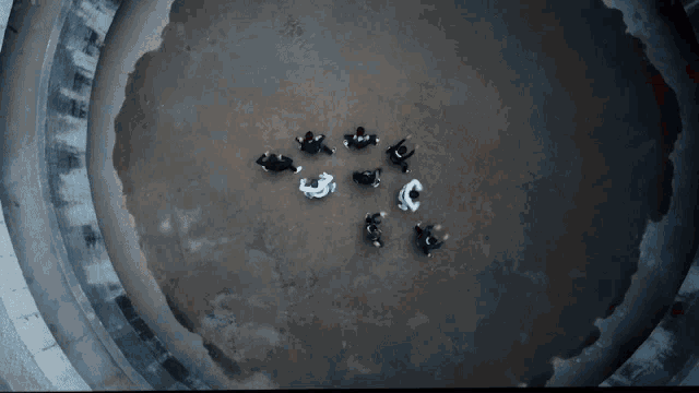 a group of people are standing in a dark room