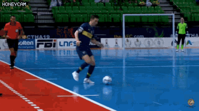 a soccer game is being played in front of a banner that says honeycam on it