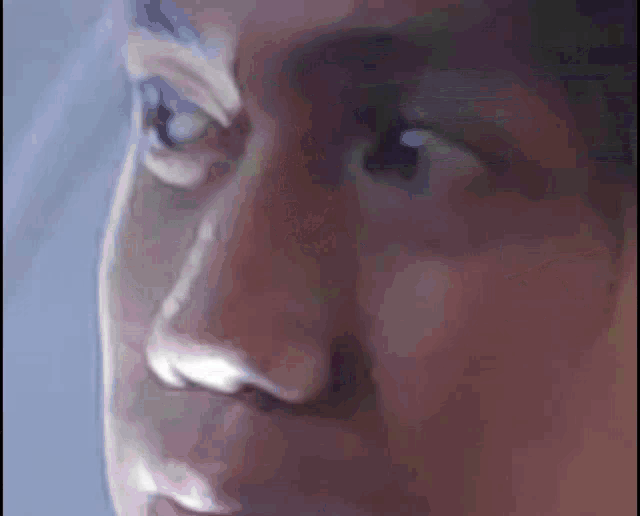 a close up of a man 's face shows his eyes