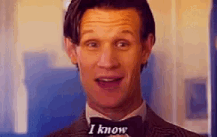 a man in a suit and bow tie is smiling and says i know .